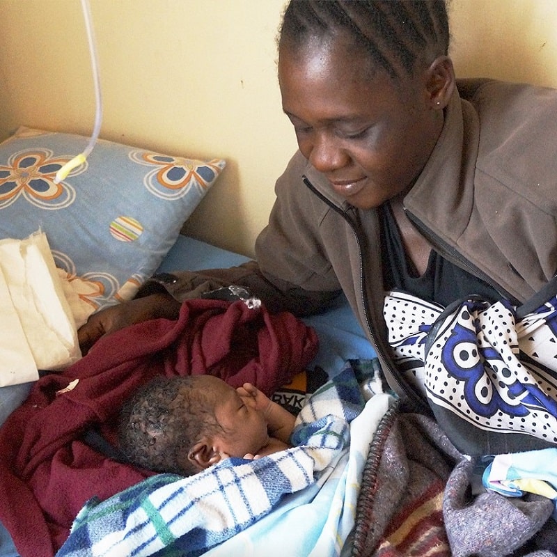 give clothing to a newborn