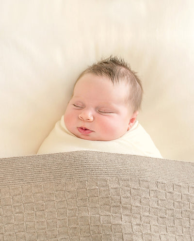 sleeping newborn baby in merino blanket