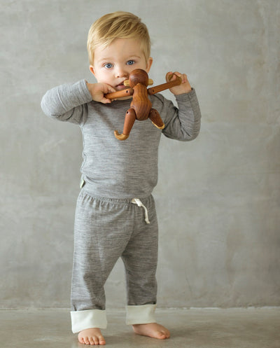 baby wearing grey long sleeve top and drawstring pants