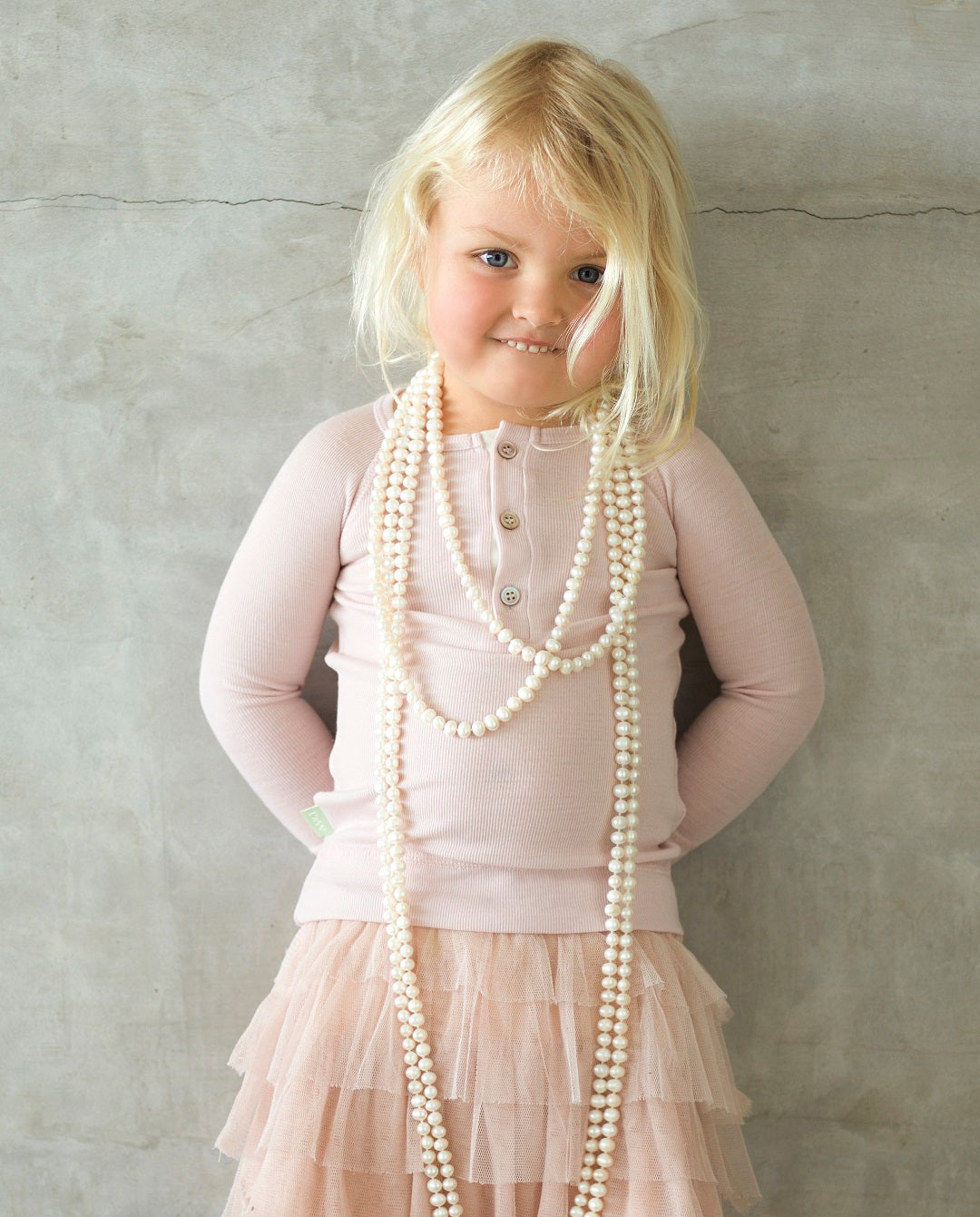 girl wearing merino junior rib top