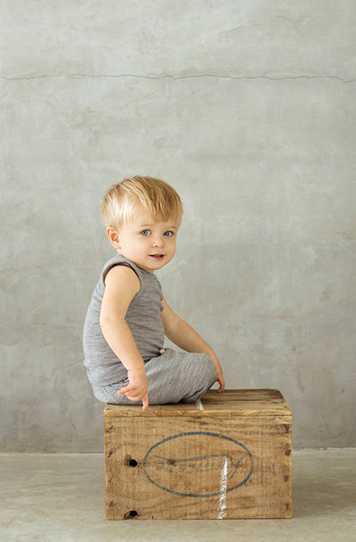 boy wearing grey merino singlet bodysuit