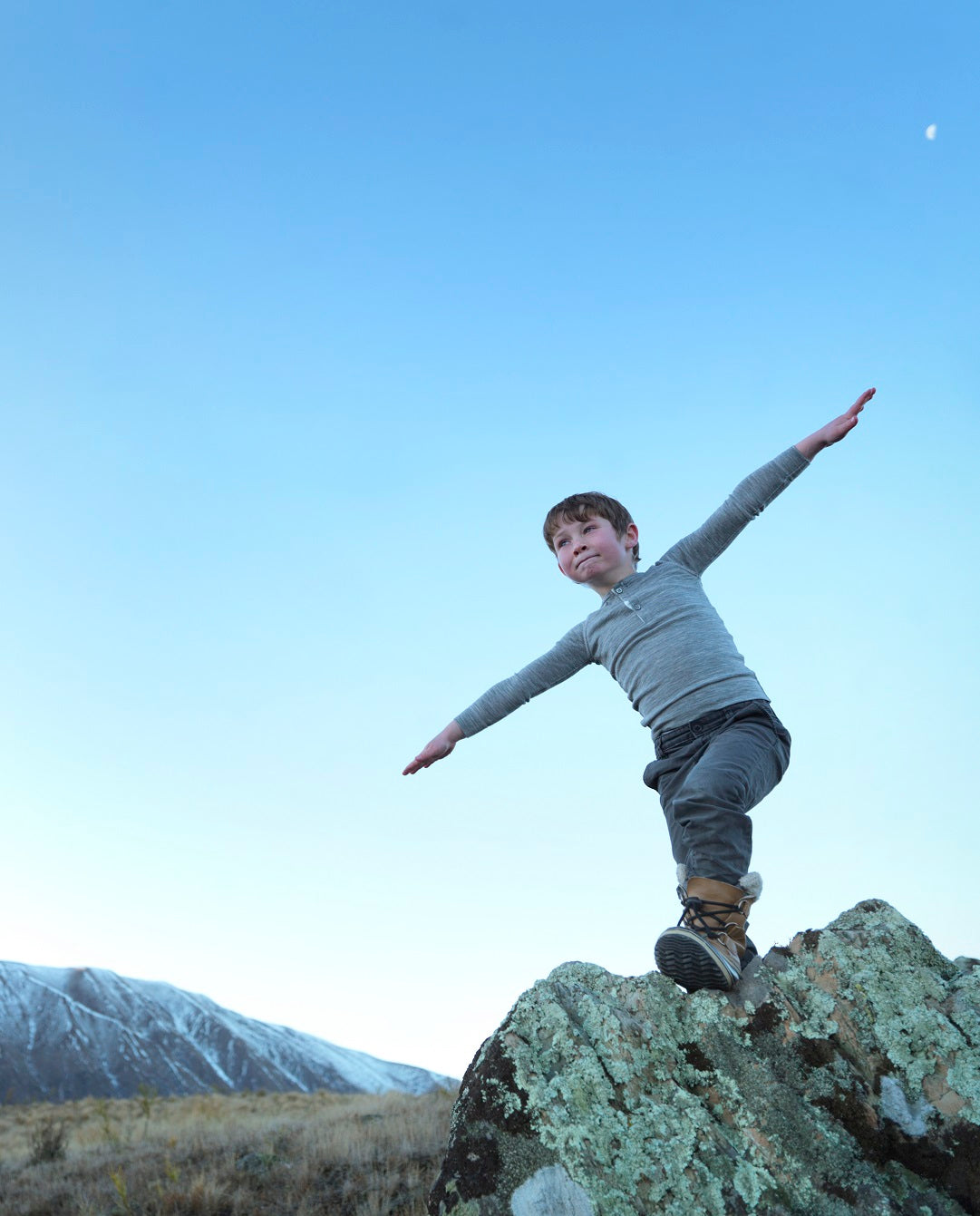 boy enjoying the outdoors wearing merino top