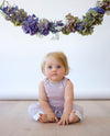 baby girl wearing merino singlet bodysuit